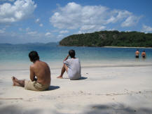 Mens sitting on the beach